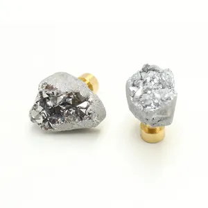 Detail of natural druzy crystal cabinet handles with polished brass cylinder bases