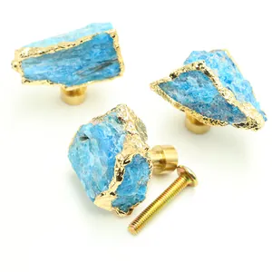 Macro detail of blue crystal stone drawer knobs with gold foil edges and brass base