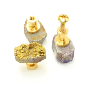 Macro view of natural crystal cluster drawer handle with brass base and screw details