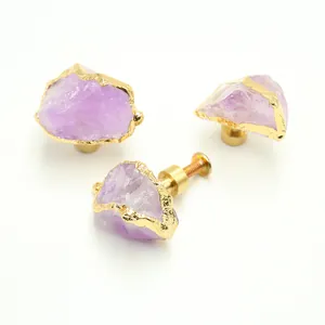 Detail of natural purple amethyst cabinet knob with brass base and mounting screw
