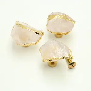 Detail shot of natural rose quartz stone drawer knob with gold brass hardware and screw