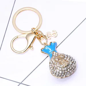 Porte-clés sac d'argent en alliage avec émail bleu, symbole dollar et strass brillants