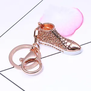 Detail of rose gold sneaker keychain with sparkling crystals and metal lobster clasp