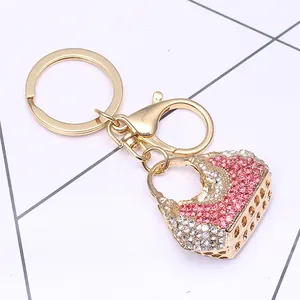Pink shell bag keychain with rhinestones and golden hardware for bags and car keys