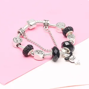DIY silver charm bracelet with black glass beads and a cartoon pendant on a snake chain