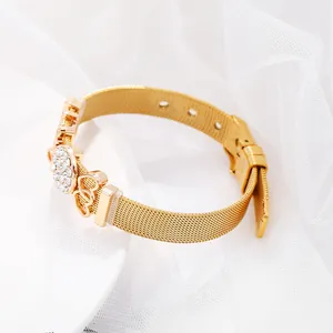 Golden stainless steel watch band bracelet with a sparkling crystal heart charm on lace