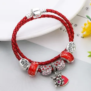 Red leather woven bracelet with silver heart beads and embracing bear charm