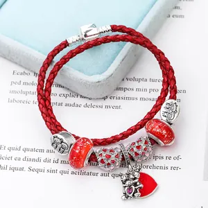 Red braided leather charm bracelet with heart-shaped pendants and glass beads