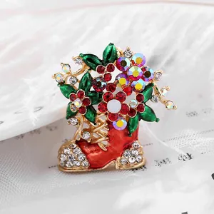 Macro de la broche botte de Noël rouge avec strass brillants et finition en émail floral