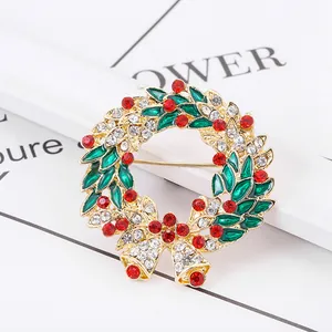 Christmas wreath brooch with green enamel leaves, red crystals and golden bells