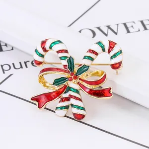 Christmas candy cane brooch with red bow and green holly leaves in enamel finish
