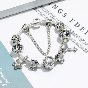Silver snake chain charm bracelet featuring butterfly and bee pendants with sparkling crystals