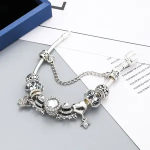Silver charm bracelet with butterfly, bee and crystal heart charms on snake chain