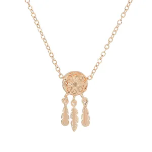 Fashionable rose gold dreamcatcher pendant necklace with feathers on white background