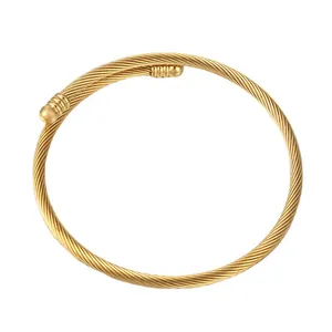 Elegant gold-plated stainless steel cable bangle with twisted texture and ball ends