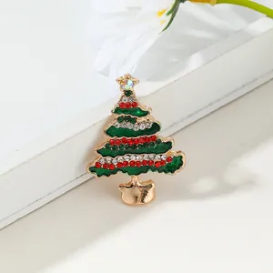 Elegant Christmas tree brooch with green enamel and sparkling rhinestones on golden alloy