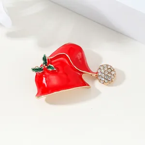 Festive red enamel Santa hat brooch with green holly leaves and sparkling crystal ball