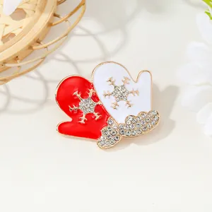 Christmas red and white glove brooch with rhinestone snowflakes on warm beige background