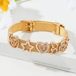 Gold mesh belt bracelet with hollow stars and sparkling heart charms on white stone
