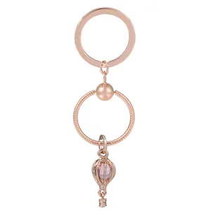 Rose gold hot air balloon keychain with purple pendant on a clean white background