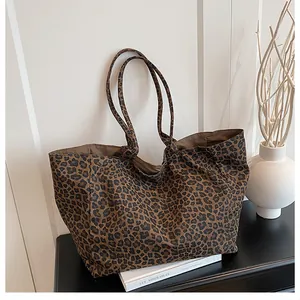 Detail of leopard print tote bag with shoulder straps for versatile autumn winter styling