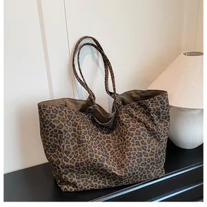 Close-up of leopard print tote bag against minimalist background with home lamp