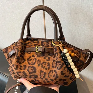 Frosted leopard print handbag with leather round handles and beaded bohemian charm