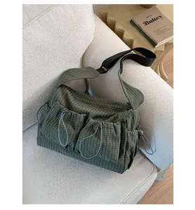 Vista dettagliata della borsa a scacchi verde scuro in nylon con tasche cargo coulisse