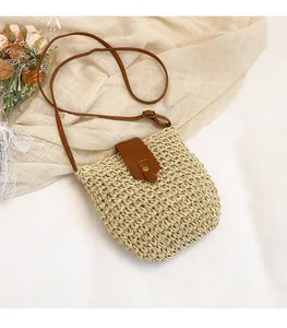 Detailed close-up of woven straw texture with brown leather flap and magnetic closure