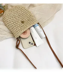 Interior view of beige woven crossbody bag showing ample space for phone and makeup