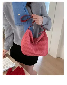 Dettaglio di una borsa hobo a quadri rossi in tela con tracolla regolabile da donna