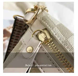 Close-up of smooth gold zipper and lychee grain leather on the stylish crossbody chest bag