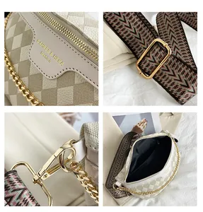 Detail view of beige crossbody bag showing metal buckle, interior space and strap texture