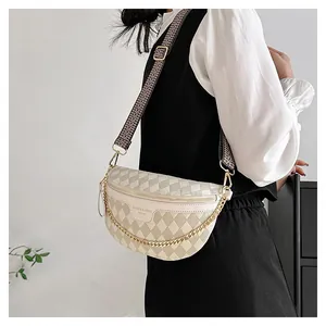 Detail of crossbody bag featuring beige quilted pattern and woven geometric strap