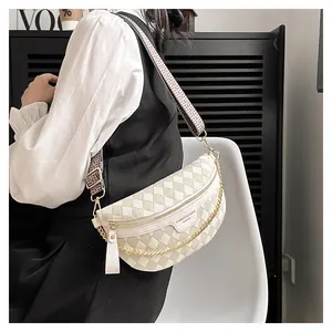 Close-up of checkered crossbody chest bag with vintage patterned strap and gold chain
