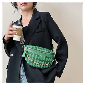 Close-up of green quilted waist bag with gold chain and woven strap detail