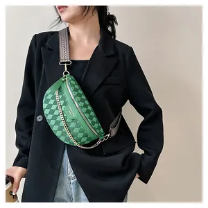 Detail of green checkerboard crossbody bag with gold chain on black blazer