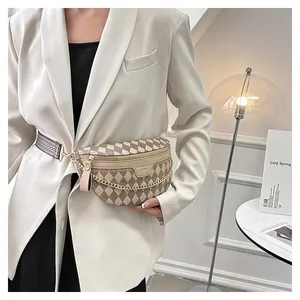 Detail of checkered crossbody bag featuring gold chain and geometric woven strap