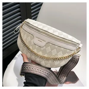 Detailed macro view of cream waist bag with quilted texture and gold chain link detail