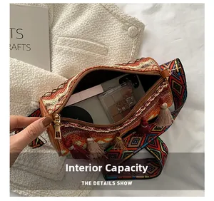 Internal capacity of bohemian cylinder bag with fringe showing lipstick and eyeshadow