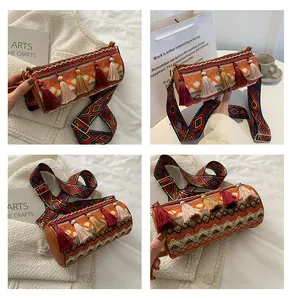 Close-up of bohemian woven cylinder bag with colorful jacquard patterns and tassels