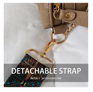 Detailansicht der khakifarbenen Leder-Tasche mit goldener Hardware und Gurt