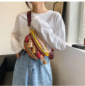 Detail of bohemian woven crossbody bag with colorful geometric patterns and tassels