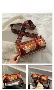 Detail of bohemian cylinder bag with colorful woven patterns and vibrant tassels