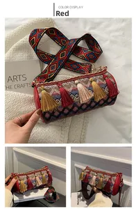 Detail of red Bohemian bucket bag with fringe and geometric wide strap close-up