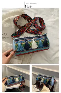 Detailed view of bohemian cylinder bag with blue tassels and ethnic woven strap