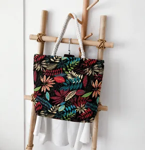 Close-up of a tropical leaf pattern canvas tote bag with white thick rope handles