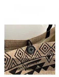 Detail of linen tote bag with geometric print and ethnic style button loop closure