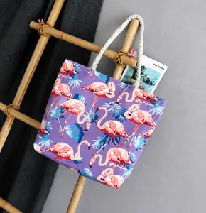 Detail of purple canvas tote bag with pink flamingo print and white cotton rope handles