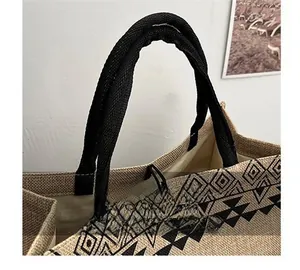 Close-up of thick woven handles and ethnic geometric patterns on linen tote bag